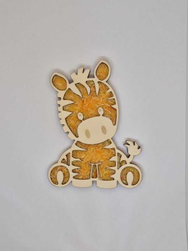 Sensorische vulvorm zebra– oranje speelrijst Houten sensorische vulvorm in de vorm van een zebra gevuld met oranje speelrijst, geschikt voor sensorisch spel en fijne motoriek.